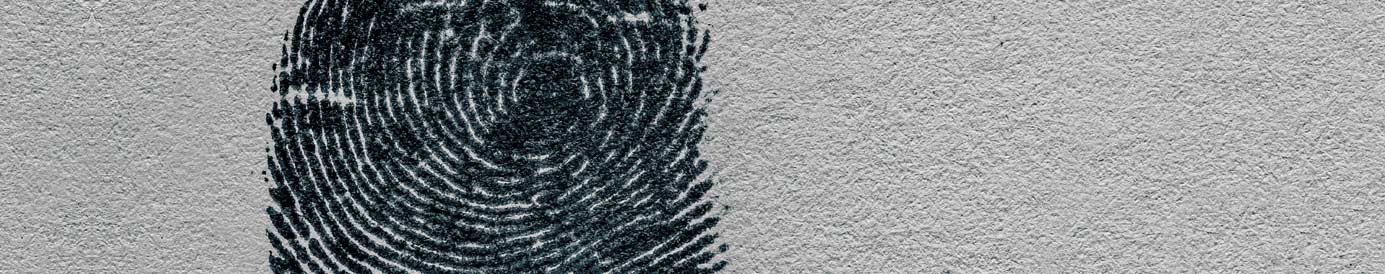 A light grey paper-textured background with a black fingerprint, slightly smudged.